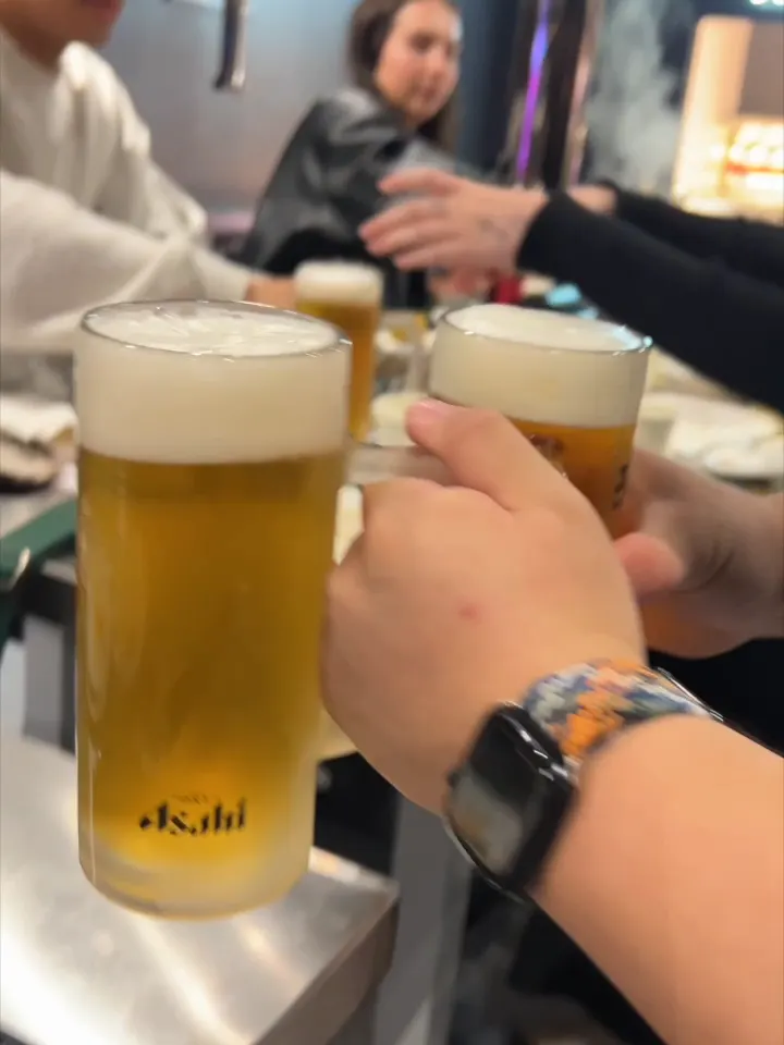 Friends cheering with beers at GOGI